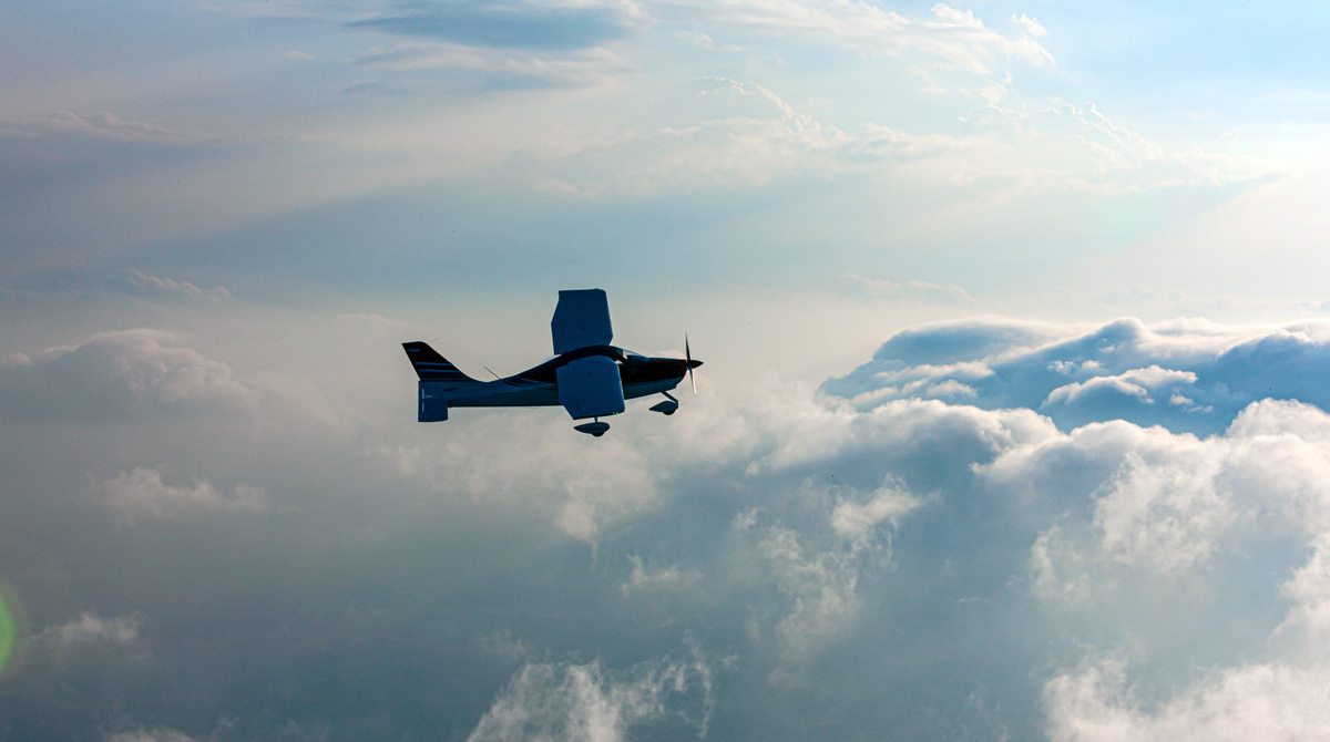 P2008 Single Engine Aircraft by Tecnam flying in the clouds