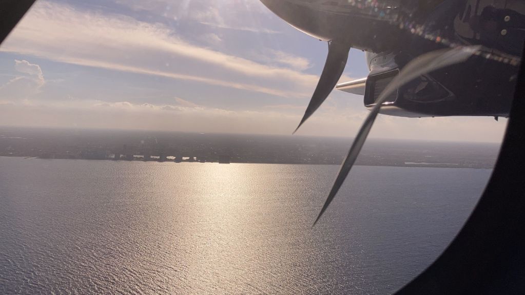 view from the airplane, purple sunset over the ocean